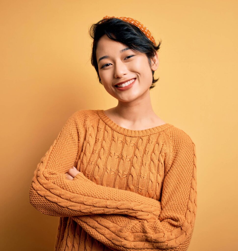Smiling woman with crossed arms